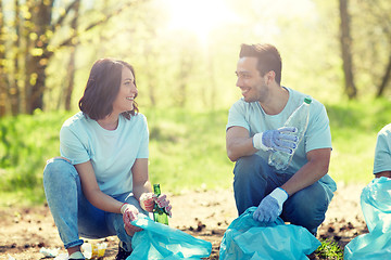 Image showing volunteers with garbage bags cleaning park area