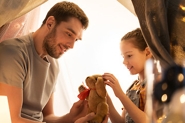 Image showing happy family playing with toy in kids tent at home