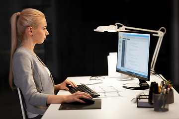 Image showing female programmer working late at night office