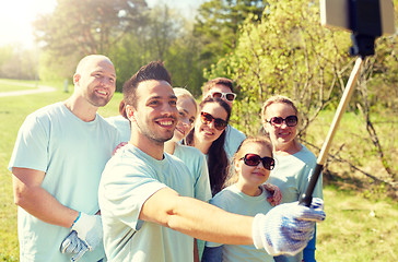 Image showing group of volunteers taking smartphone selfie