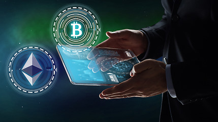 Image showing businessman with tablet pc and cryptocurrency