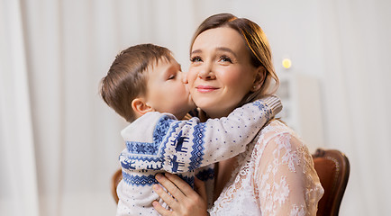 Image showing happy little son kissing his mother