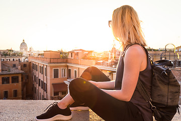 Image showing Female tourist enjoying beautiful view of at Piazza di Spagna, landmark square with Spanish steps in Rome, Italy at sunset.