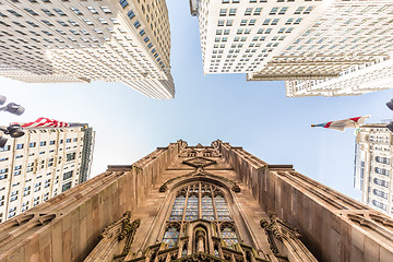 Image showing Wide angle upward view of Trinity Church at Broadway and Wall Street with surrounding skyscrapers, Lower Manhattan, New York City, USA