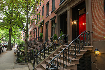 Image showing Row of old brownstone buildings along an empty sidewalk block in the Greenwich Village neighborhood of Manhattan, New York City NYC