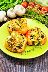 Image showing Pepper stuffed with mushrooms and couscous in plate on wood