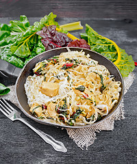 Image showing Funchoza with chard and meat in pan on wooden board