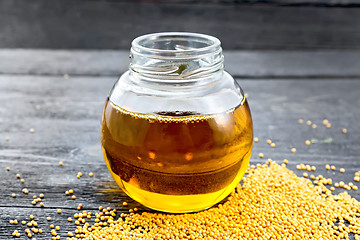 Image showing Oil mustard in jar on board