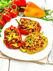 Image showing Pepper stuffed with meat and couscous in white plate on board