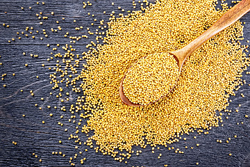 Image showing Mustard seeds in spoon on board top