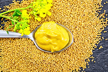 Image showing Sauce mustard in spoon with flower on board top