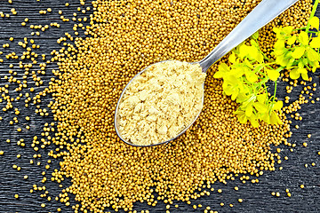 Image showing Mustard powder in spoon with flower on board top