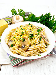 Image showing Fusilli with mushrooms and cream on light board