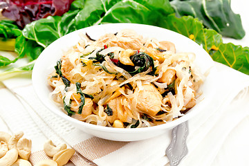 Image showing Funchoza with chard and cashew in bowl on light board