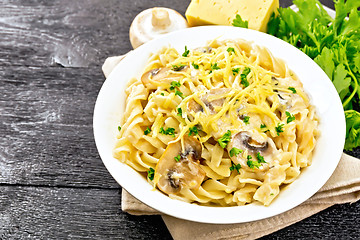 Image showing Fusilli with mushrooms and cream in plate on board