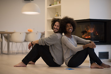 Image showing multiethnic couple with tablet computer on the floor