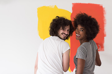 Image showing multiethnic couple painting interior wall