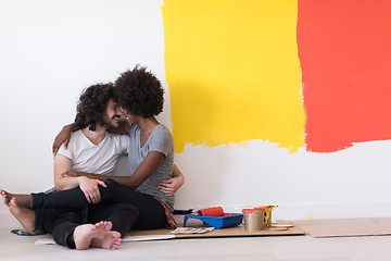 Image showing young multiethnic couple relaxing after painting