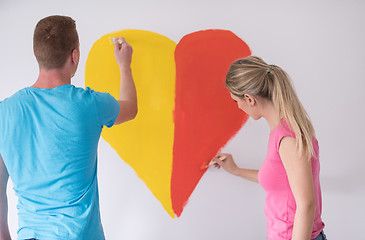 Image showing couple are painting a heart on the wall