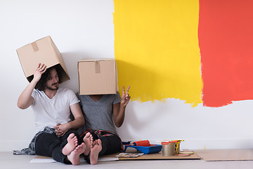 Image showing young multiethnic couple playing with cardboard boxes