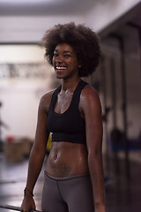 Image showing black woman lifting empty bar