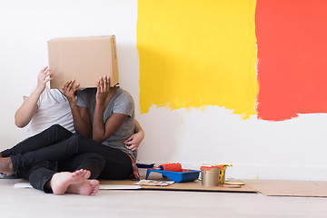 Image showing young multiethnic couple playing with cardboard boxes