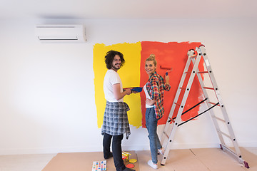 Image showing couple painting interior wall