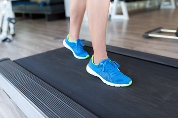 Image showing Woman running on the treadmill at the gym