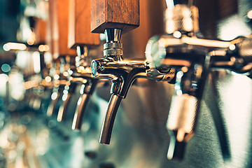 Image showing Beer taps in a pub