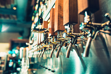 Image showing Beer taps in a pub