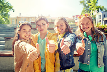 Image showing happy students or friends showing thumbs up