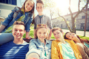 Image showing happy teenage students or friends taking selfie