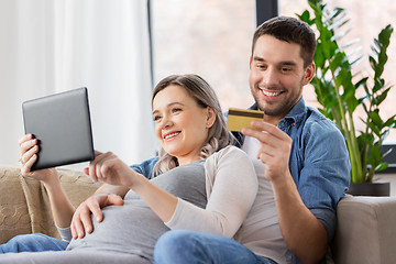 Image showing man and pregnant wife shopping online at home