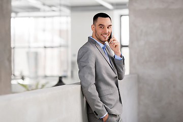 Image showing businessman calling on smartphone at office