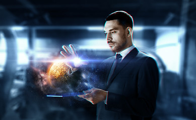 Image showing businessman with transparent tablet and planet