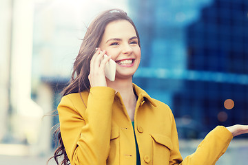 Image showing smiling young woman or girl calling on smartphone