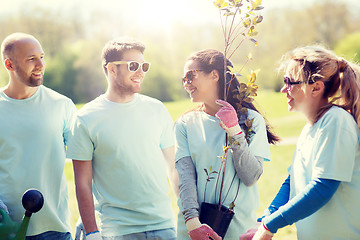 Image showing group of volunteers with tree seedling in park