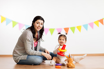 Image showing mother and baby daughter playing with pyramid toy