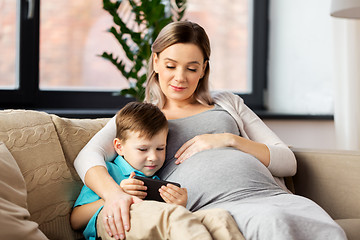 Image showing pregnant mother and son with smartphone at home