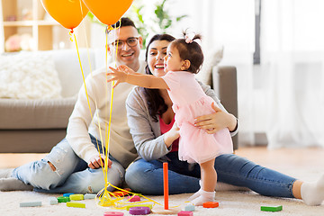 Image showing baby girl reaching to balloons at birthday party