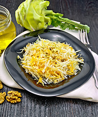 Image showing Salad of carrot and kohlrabi with honey in plate on dark board