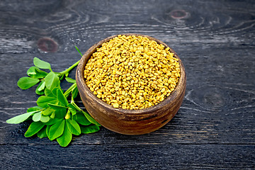 Image showing Fenugreek with green leaf in clay bowl on black board