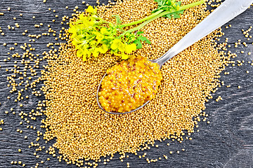 Image showing Sauce mustard Dijon in spoon with flower on board top