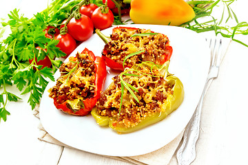 Image showing Pepper stuffed with meat and couscous in white plate on table