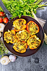 Image showing Pepper stuffed with mushrooms and couscous in pan on board top
