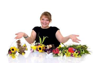 Image showing Young girl arranging flowers