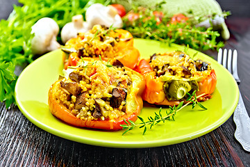 Image showing Pepper stuffed with mushrooms and couscous in green plate