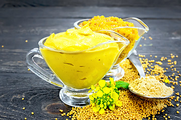 Image showing Sauce mustard in two sauceboats with powder on black board