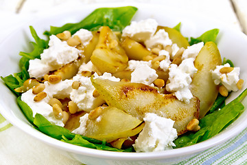 Image showing Salad from pear and spinach with feta in dish on board