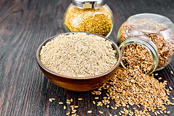 Image showing Flour linen in bowl with seeds in glass jars on wooden table